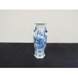 An 18th Century Oriental blue and white vase with hexagonal top over faceted body,