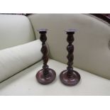 A pair of oak barley twist candlesticks,