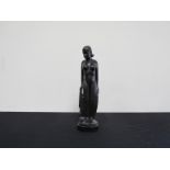 A mid 20th Century Carved hardwood naked female on faceted plinth,