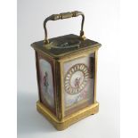 A 19th Century French brass carriage clock with highly engraved case and handle,