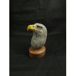 A carved and painted model of a bald eagle