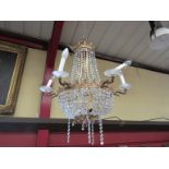 A French ornate crystal glass electrolier with nine light sconces,