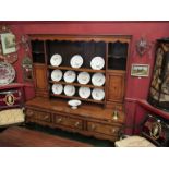 A Georgian provincial oak dresser crossbanded in mahogany (veneer a/f),