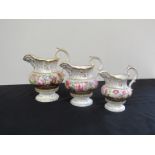 A set of three Rockingham graduated jugs