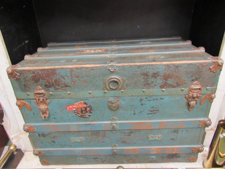 A late Victorian trunk, lathe bound body with labels and script painted green,