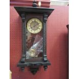 A late 19th Century Vienna style clock with embossed circular brass dial, Roman numerals,