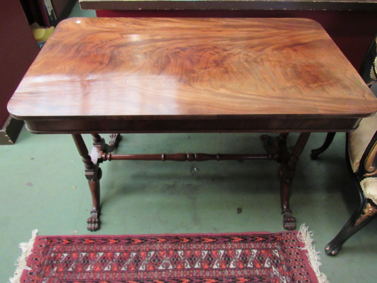 A Victorian mahogany centre table with twin pillar supports, two paw feet,