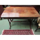 A Victorian mahogany centre table with twin pillar supports, two paw feet,
