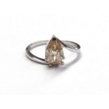 An 18ct white gold ring set with pear shaped brilliant cut diamond colour fancy brownish yellow,