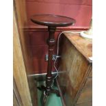 A 19th Century style mahogany jardiniere stand the circular dished top over a turned and reeded