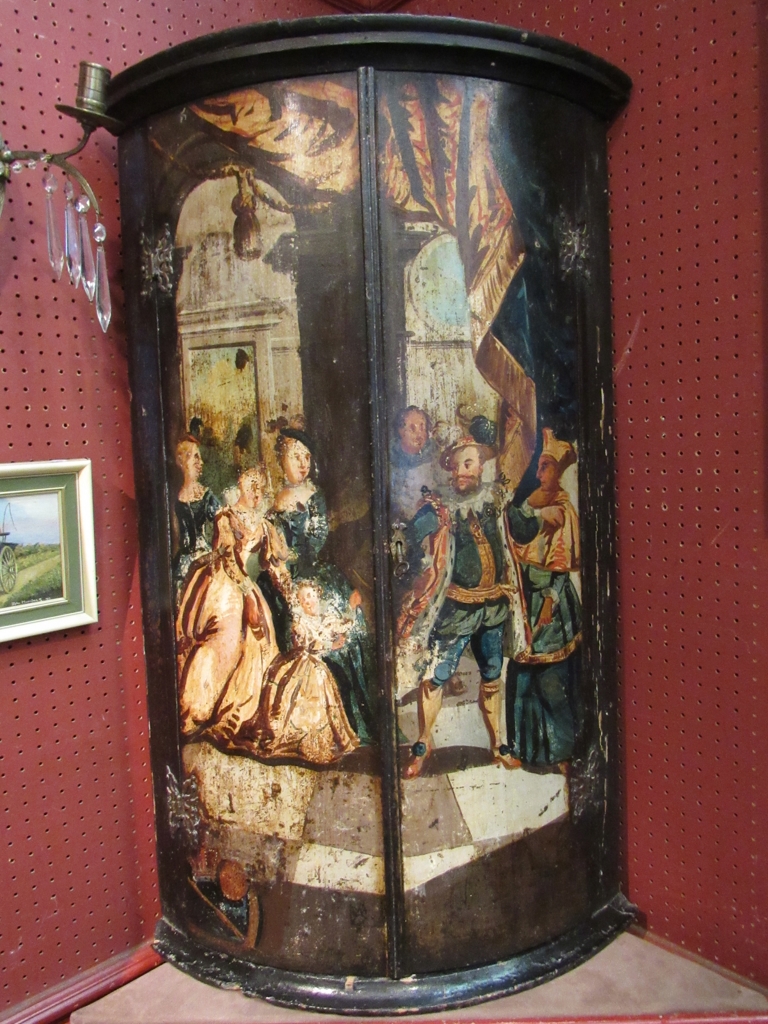 A late 18th Century continental corner cupboard with painted figural detail,