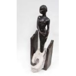 A modern sculpture of a lady standing in running water. Copper resin.