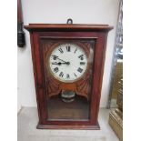 An early 20th Century oak cased wall clock with Roman dial and 8-day spring driven movement,