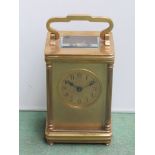 A late 19th Century French brass carriage clock in gourge case, with fluted column supports and key,