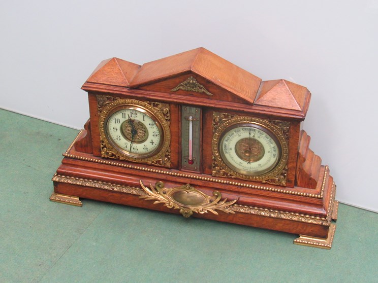 A Victorian oak and brass mounted clock with barometer and aneroid thermometer,