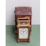 An early 20th Century brass carriage clock with pierced gourge case,