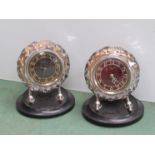 Two Russian Mayak 8-day desk clocks in faceted glass frames, bakelite bases, red and blue dials,