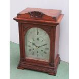 An Edwardian oak mantel clock by Gustav Becker with silvered Roman dial and three train movement,