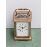 An early 20th Century brass carriage clock with Roman enamelled dial, side panel a/f, with key,