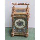 A 19th Century French brass carriage clock with enamelled dial and turned pillars, key,