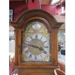 An early 20th Century oak longcase clock, brass arched dial with ormolu spandrels,