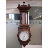 A Victorian carved oak pendant barometer with thermometer