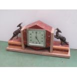 An Art Deco French marble mantel clock surmounted by two cast gazelles, Arabic silvered dial,