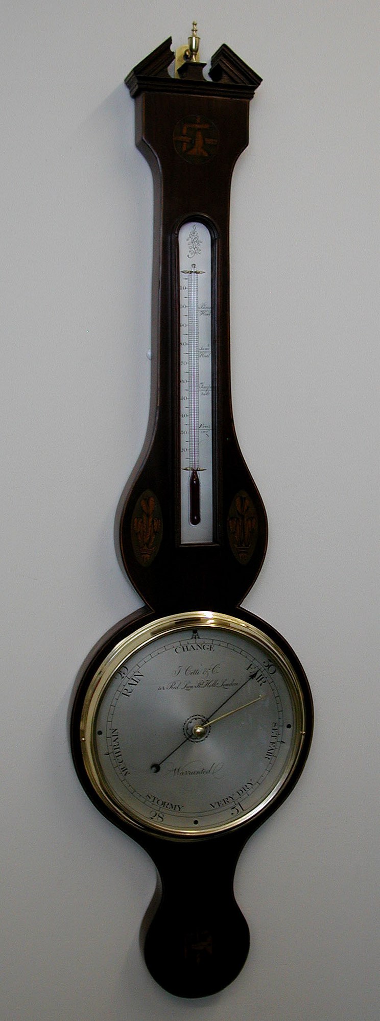 An 8" broken pediment mahogany strung wheel barometer,