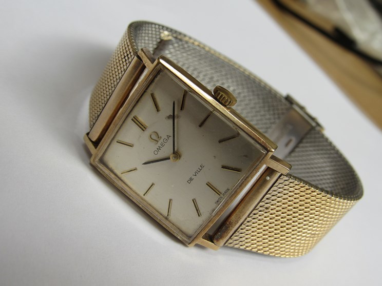 OMEGA: A De Ville 9ct gold square cased gent's wristwatch with silvered dial and associated