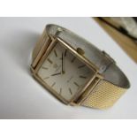 OMEGA: A De Ville 9ct gold square cased gent's wristwatch with silvered dial and associated