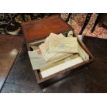 A wooden box containing a quantity of assorted world stamps