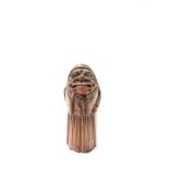 A 19th Century carved knop in the form of a gentleman,