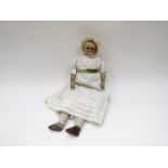 A mid 19th Century wax faced doll with leather arms,