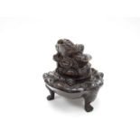 A Chinese bronze censor in the form of the three toads with another surmounting lid.