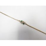 An 18ct gold diamond and emerald bracelet