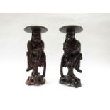 A pair of Japanese Oriental carved boxwood figures, circa 1880, with carved ivory eyes and teeth,