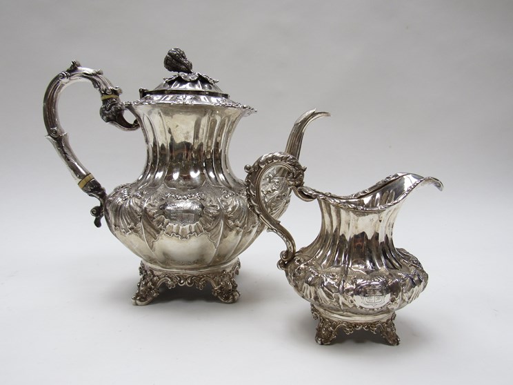 An early Victorian silver teapot and milk jug, each of fluted baluster form,