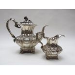 An early Victorian silver teapot and milk jug, each of fluted baluster form,