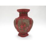 A Chinese cinnabar vase, carved panels depicting tea ceremony etc, character marks to base,