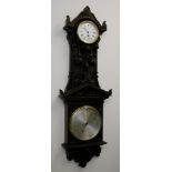 An 8" finely carved dark oak pendant aneroid barometer with eight day clock by Negretti & Zambra,