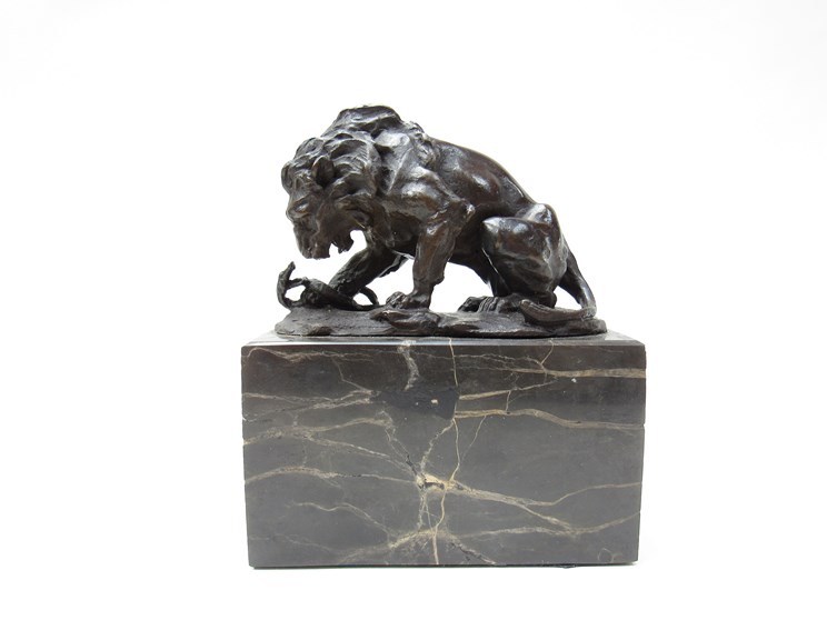 A bronze lion and snake on marble plinth,