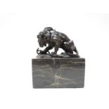 A bronze lion and snake on marble plinth,