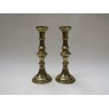 A pair of 19th Century brass candlesticks, 25.