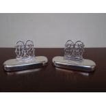 Two Sampson Mordan & Co silver name place holders with monogram clasp, weighted bases,