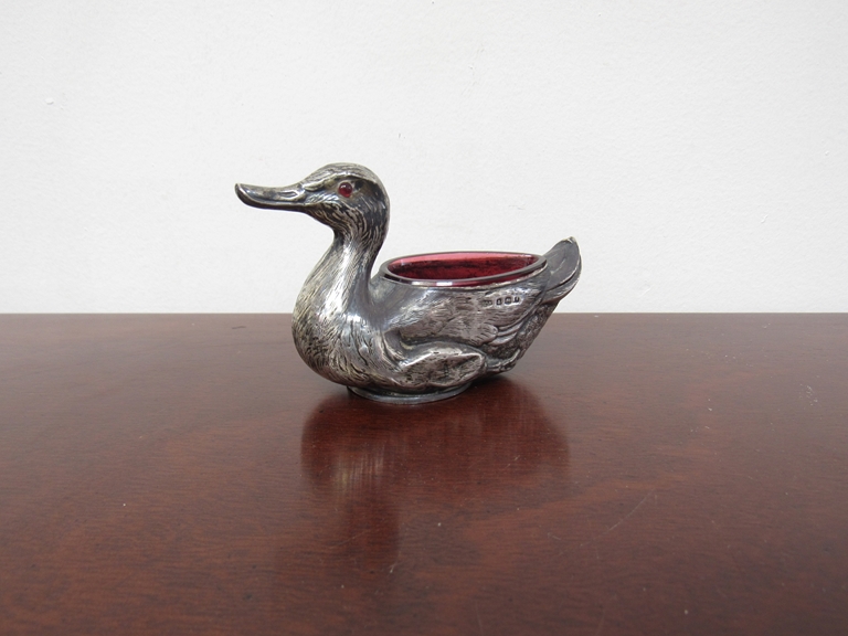 A silver salt as a duck with red glass liner, one eye missing, RD 473919, Birmingham,