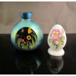 An Okra glass vase in blue tones with cottage flower design,