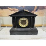 A late 19th Century black slate mantel clock of architectural form