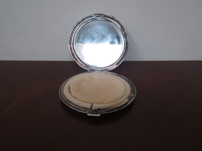 A silver compact with engine turned detail set with later porcelain plaque depicting three female - Image 2 of 2