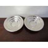 A pair of silver US dollar coin dishes, 10cm diameter,