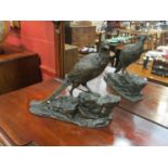 A cast figure of a pheasant standing on naturalistic base,